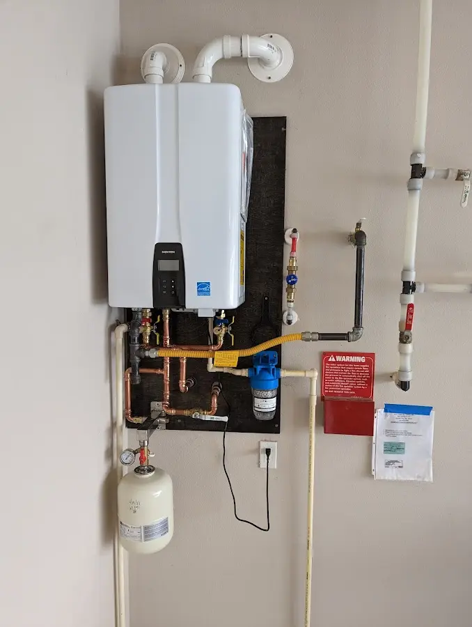 Professional plumber installing copper piping in a Fordyce home